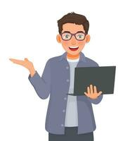 Young businessman with glasses using laptop showing hand for copy space vector