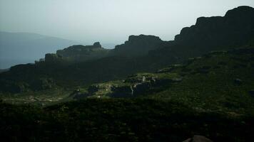 A view of a mountain range from the top of a hill video