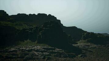 A large rocky mountain with a sky in the background video