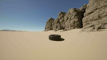 A tire sitting in the middle of a desert video