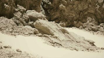 A group of rocks on a sandy beach video