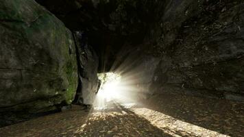Empty road goes through the cave with glowing end video