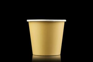 AI generated Side view yellow empty disposable paper fast food cup isolated on black background. Generative AI photo