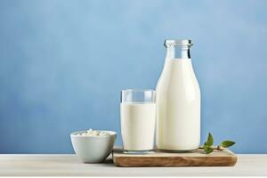 AI generated A bottle of milk and a glass of milk on a wooden table on a blue background. AI Generated photo