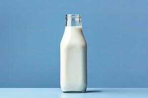 AI generated A glass bottle with full milk on blue background. AI Generated photo