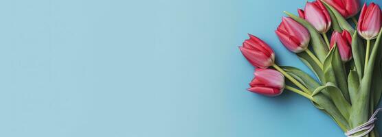 AI generated Bouquet of red tulip on blue Background. Top view with copy space.  AI Generated photo