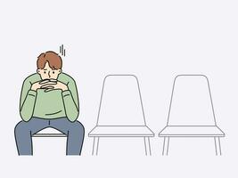 Sad man is waiting for start of interview, sitting in office corridor with empty chairs. Guy is nervous before interview because of problems in labor market and difficulty of finding well-paid job vector