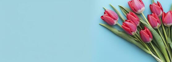 AI generated Bouquet of red tulip on blue Background. Top view with copy space.  AI Generated photo