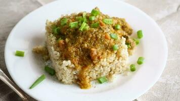 cooked bulgur with meat sauce and vegetables in a plate video