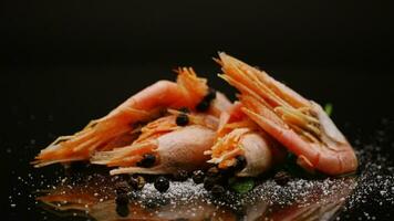 boiled shrimp with spices on black background video