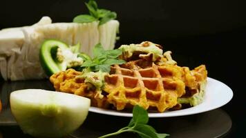 cooked two-color vegetable waffles made from cabbage and carrots. video