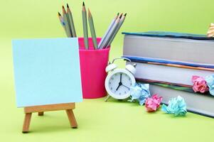 A small easel with a sticker with the inscription Back to School on the background of the educational installation. photo