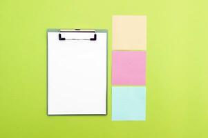 Blank clipboard and colorful stickers. Copy space. photo