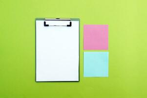 Blank clipboard and colorful stickers. Copy space. photo