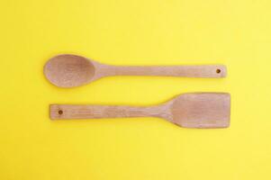 A set of bamboo dishes on a bright yellow background. photo