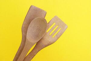 A set of bamboo dishes on a bright yellow background. photo