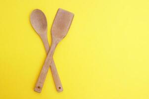 A set of bamboo dishes on a bright yellow background. photo
