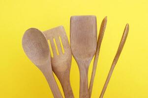 A set of bamboo dishes on a bright yellow background. photo
