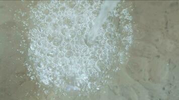 Air bubbles on surface of water arising from water flow. video