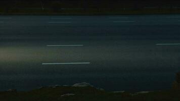 Cars move along highway with their headlights on at night. video