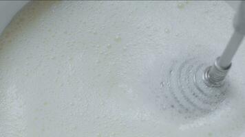 Whipping cream using hand whisk, close-up. video