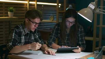Hipster business team while working on drawing in loft office using tablet video