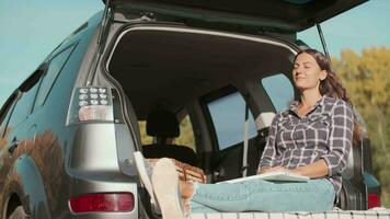 Online business, Remote learning, Wi-fi technology, Woman traveler. Woman freelance traveler relaxes while sitting in the car video