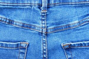 Flat lay, denim jeans leg seam detail, background texture. photo