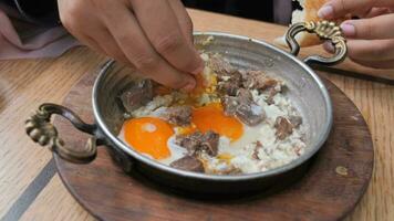 Turkish scrambled eggs with roasted meat in copper pan video