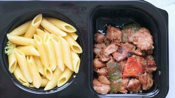 pasta, chicken and salad in a take away plastic packet on table video