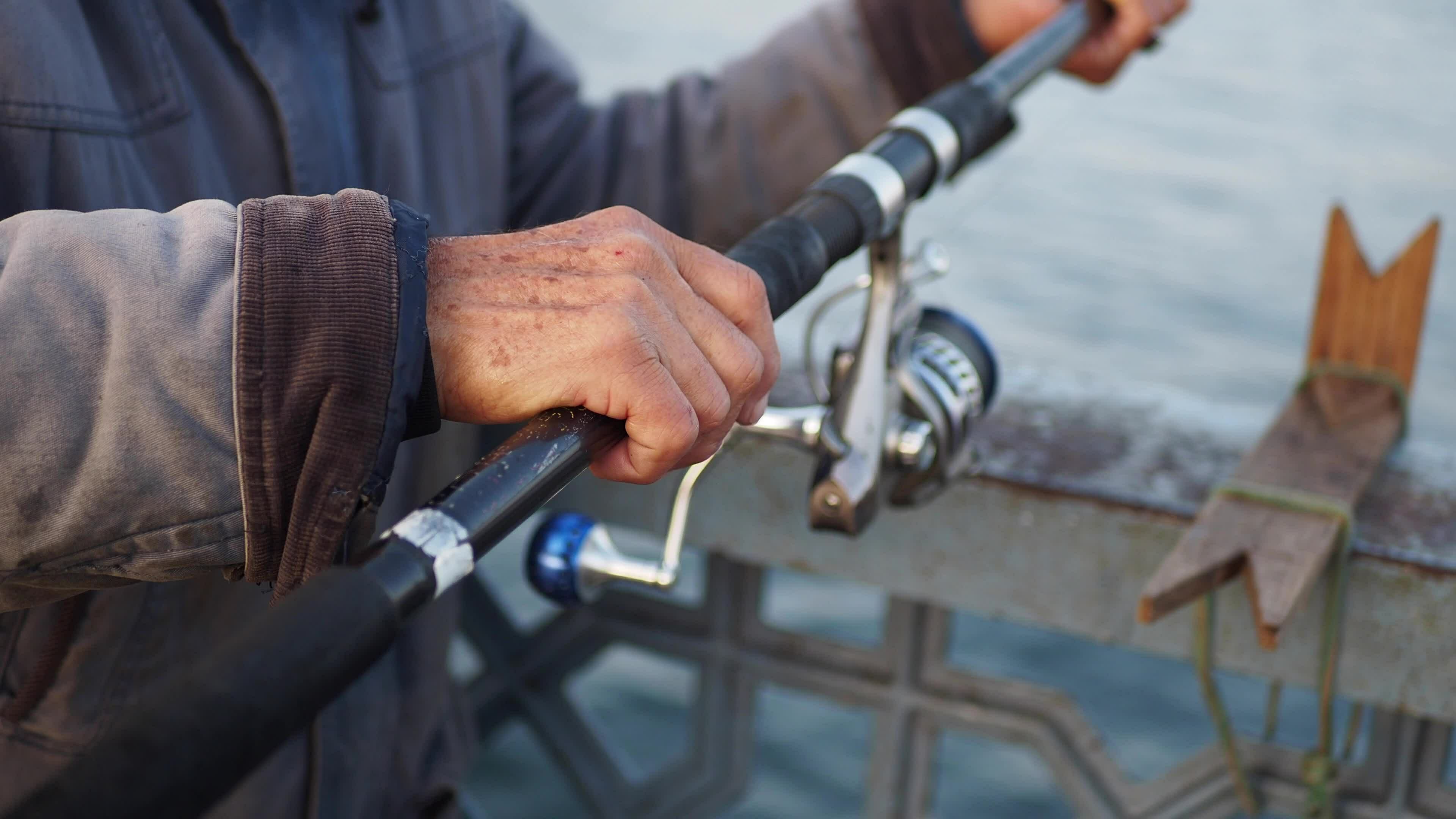 Fisherman with rod, spinning reel , 36019013 Stock Video at Vecteezy