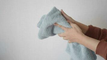 girl drying her hands in a white towel, video