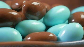 round shape chocolate candy in blue and brown color in a bowl video