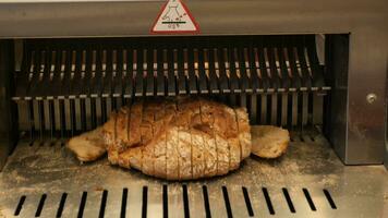 Automatic bread slicer. Slicing bread at the bakery video