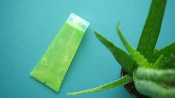 Fresh aloe vera sliced and liquid gel in plastic container on white background video