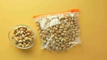 cashew nuts in a plastic packet on color background video