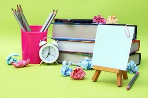 A small easel with a sticker with the inscription Back to School on the background of the educational installation. photo