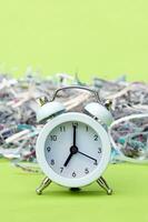 A white vintage clock in the foreground of 700 am on a light green background. photo