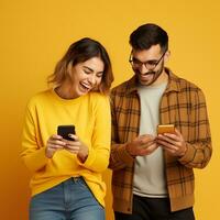 AI generated Young smiling happy couple wear casual clothes hold in hand use mobile isolated on yellow light background studio portrait. photo
