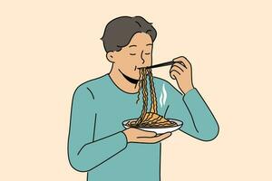 asiático hombre come ramen con chino palos, disfrutando gusto de tradicional nacional comida desde coreano cocina restaurante. chico soportes y disfruta comiendo ramen o tallarines a obtener suficiente durante trabajo descanso vector
