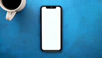 AI Generated top view of a mock up mobile phone on blue background with coffee cup photo