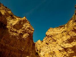 Rugged canyon walls under a clear blue sky. photo