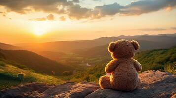 AI generated Back view of teddy bear toy sitting with background of mountain view at sunset photo