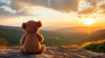 AI generated Back view of teddy bear toy sitting with background of mountain view at sunset photo