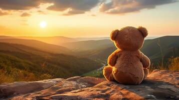 AI generated Back view of teddy bear toy sitting with background of mountain view at sunset photo