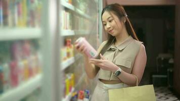 A young asian woman shopping in supermarket , concept of city life lifestyle video