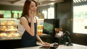 An Asian young Cashier woman working in  supermarket video