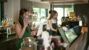 joven asiático Servicio dispuesto barista con cliente en café tienda video