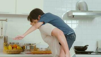 Happy Young Asian father and son cooking in kitchen at home video