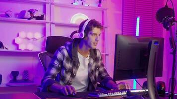 Young Caucasian man Pro Gamer have live streaming  and chatting  with his  fans at home video